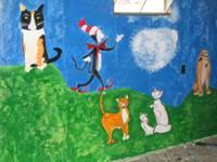 mural featuring cartoon cats including Cat in the Hat and the Lion King