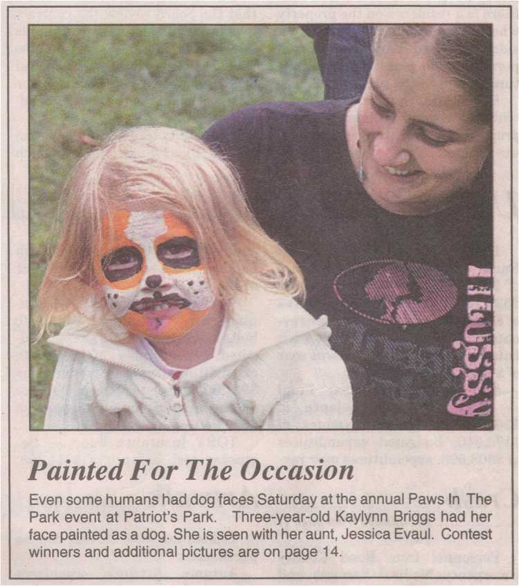 Photo - girl with face painted to look like a puppy dog
