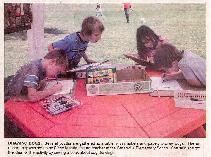 Photo - Children draw art about dogs or other animals at the activity tent