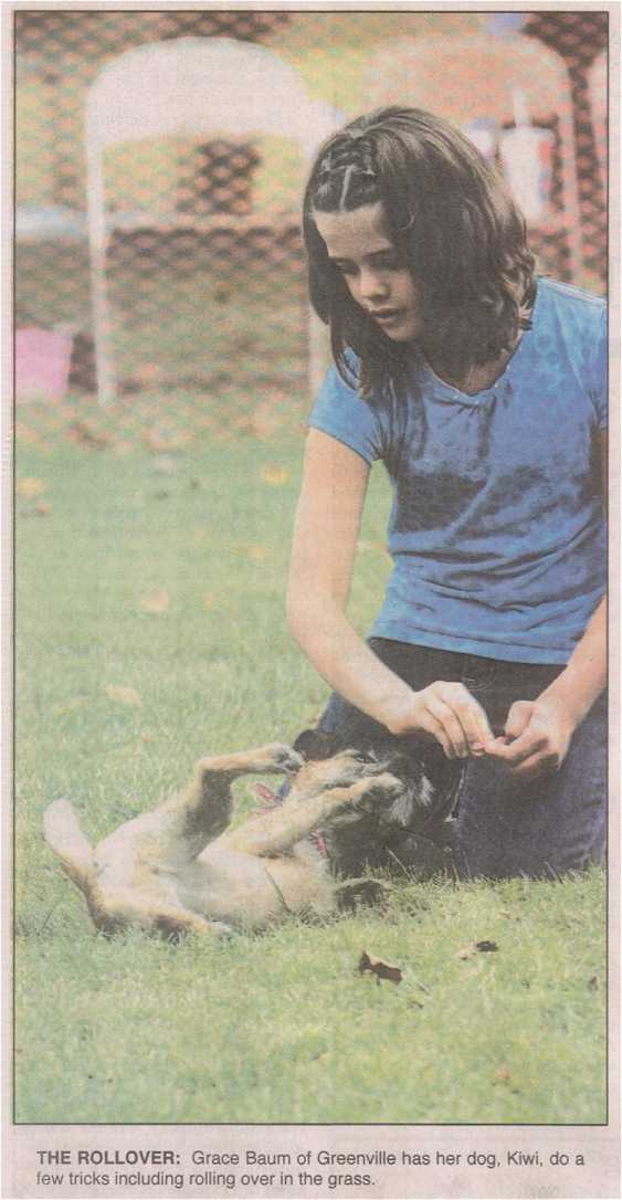 Photo - girl and dog performing roll over tricks in contest