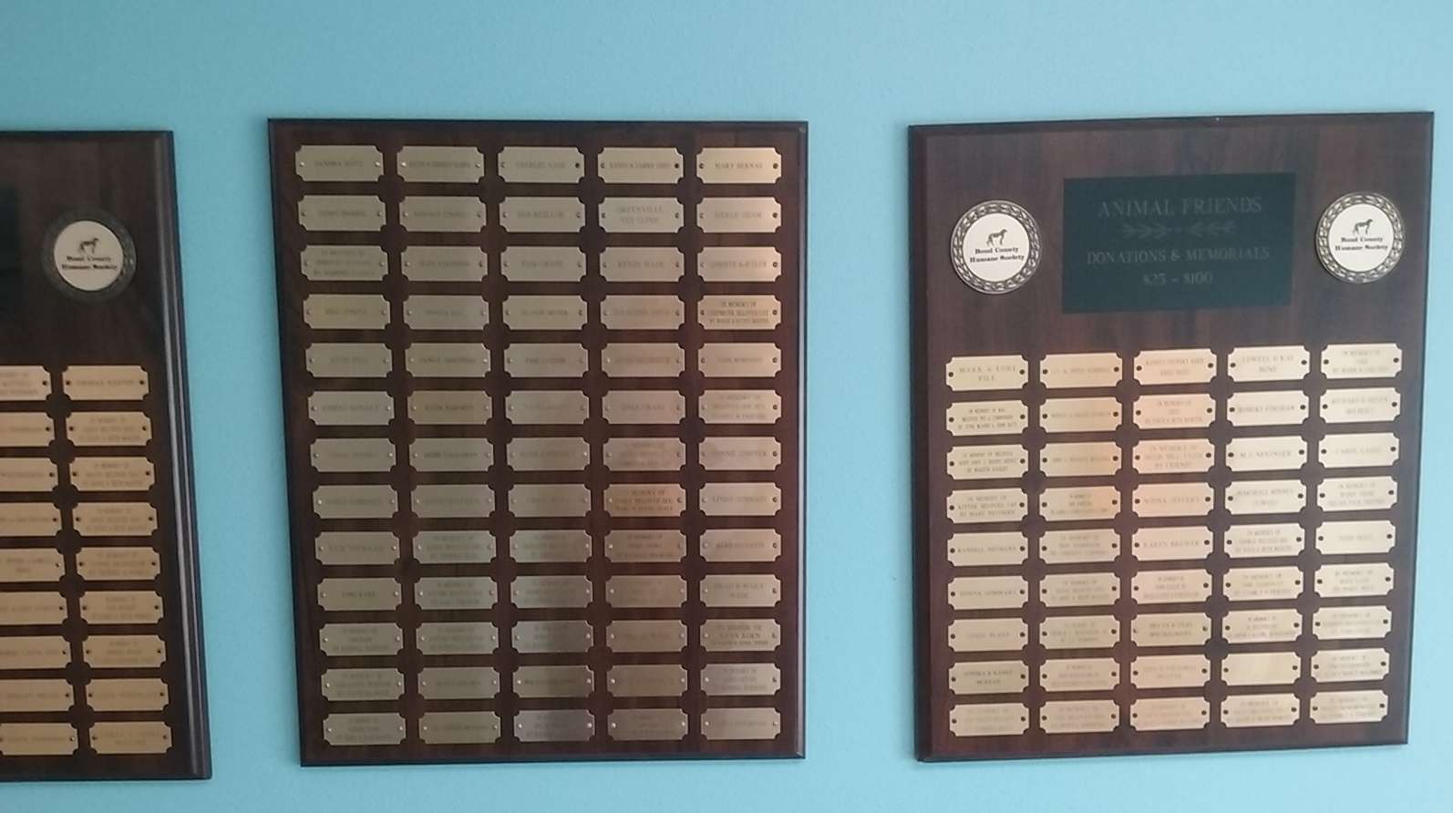 Plaques displayed Office and Adoption Center's Memory Wall