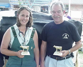 Dr Jennifer Ostrom and Dennis Hundsdorfer hold their Dairy Day milking trophies